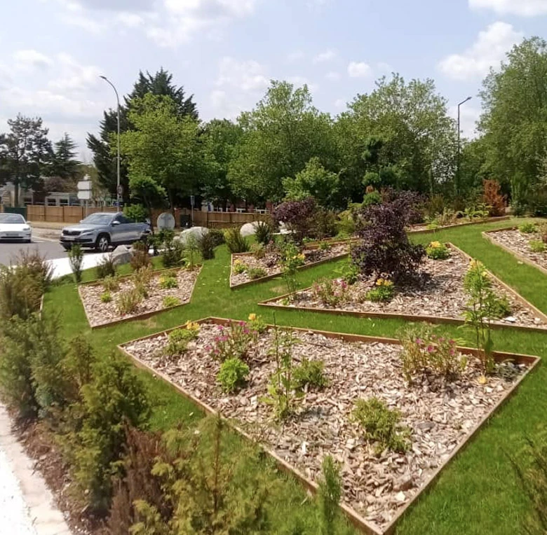 Jardin résidentiel moderne avec terrasse surélevée en bois et escalier béton
